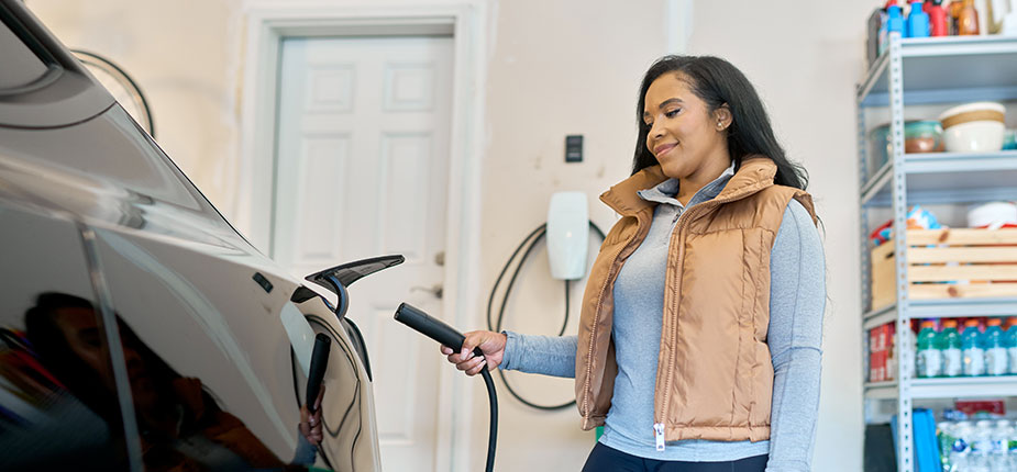 Woman charging her EV at home